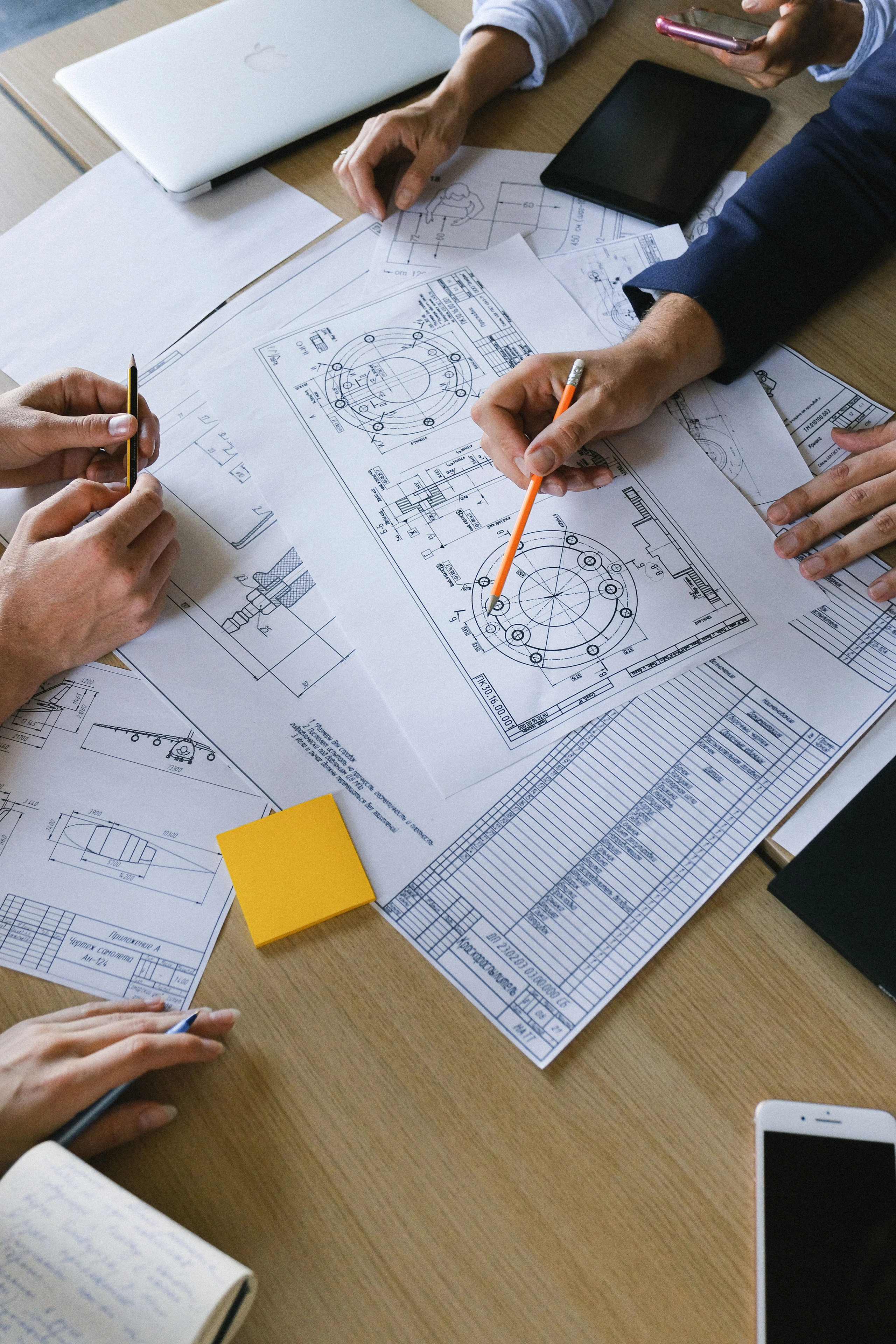 Engineering plans reviewed during a project consultation — illustrative stock photograph